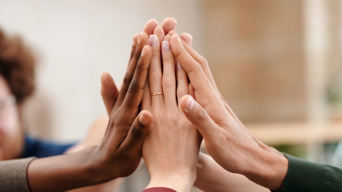 Diverse hands high-five